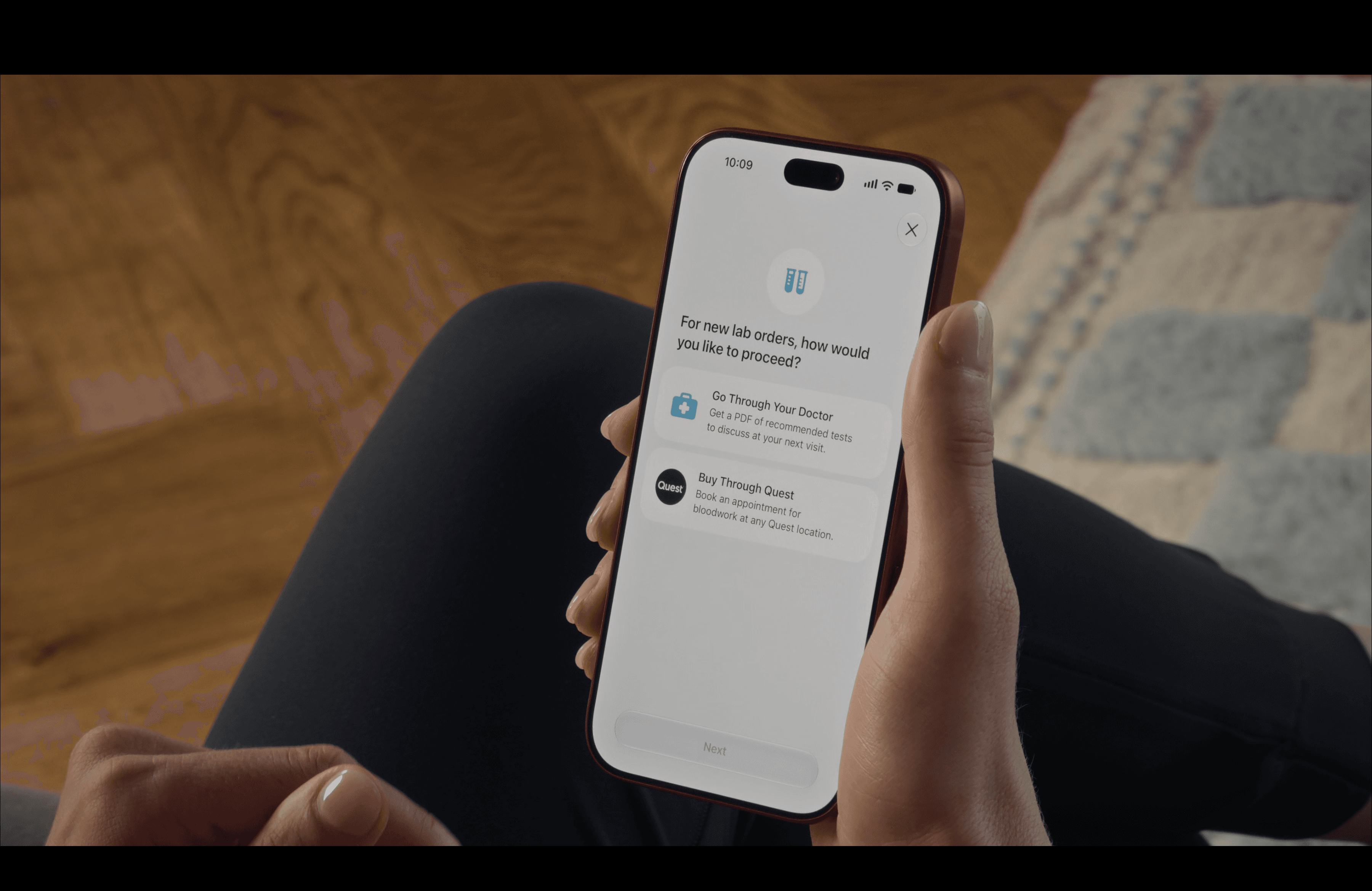 An iPhone lab ordering screen offering Go Through Your Doctor for a PDF of recommended tests, or Buy Through Quest to book a bloodwork appointment.
